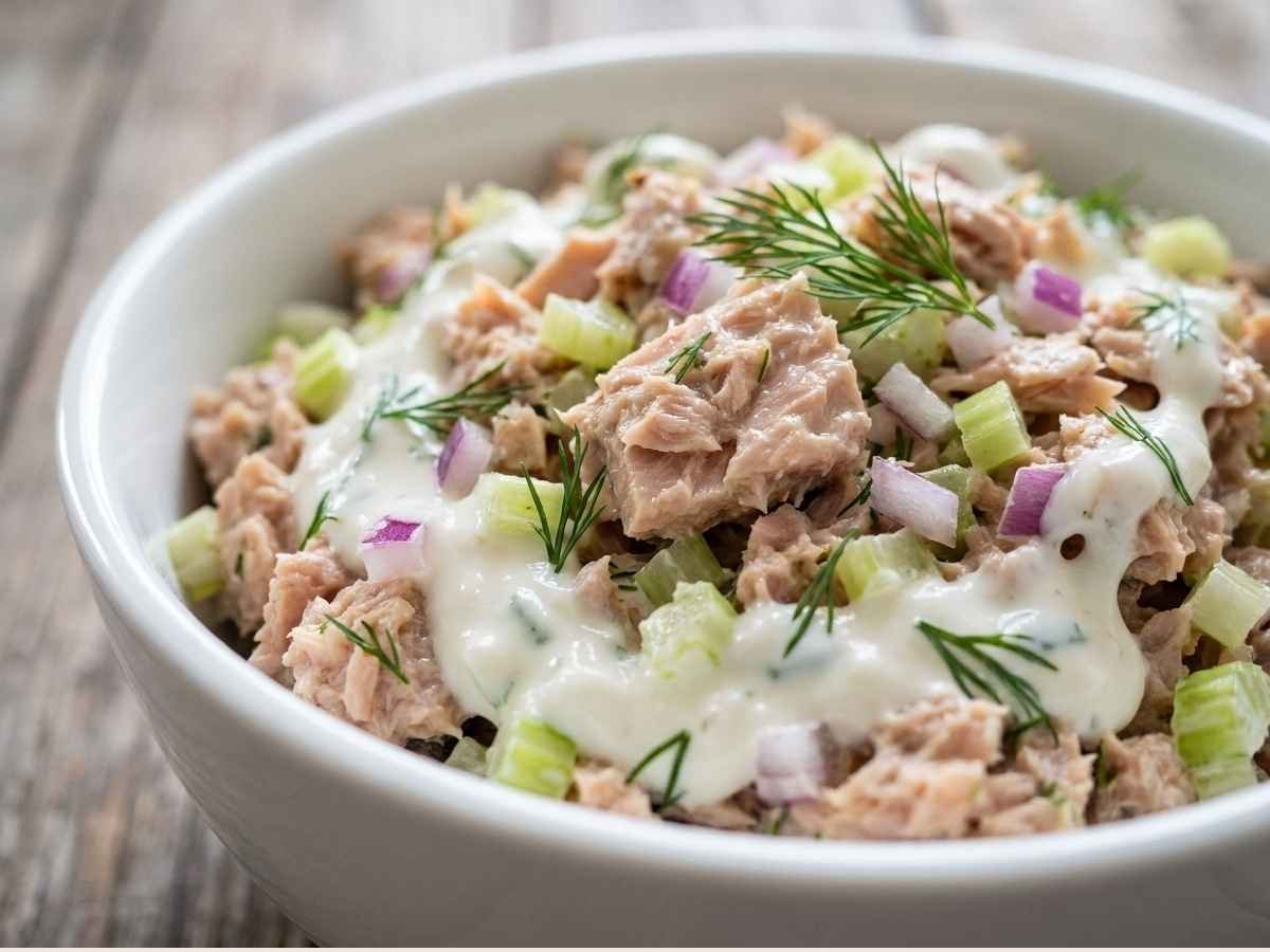 No-mayo tuna salad made with Greek yogurt, celery, red onion, lemon juice, and fresh dill — served in a bowl with crackers